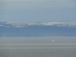 SX08279 Sailboat at Devon coastline taken across bay from Ogmore by Sea.jpg